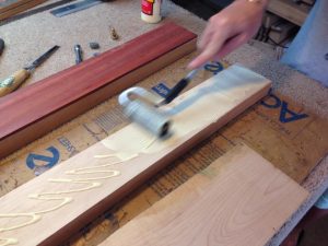Rolling the titebond glue onto one of the maple stripes.