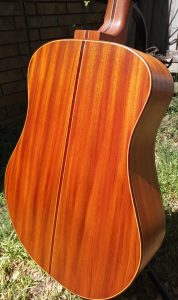Back of mahogany dreadnought acoustic guitar.